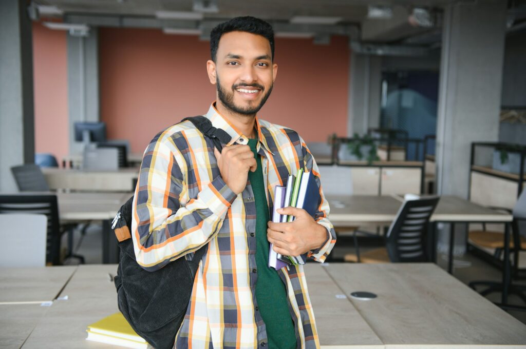 Happy indian male student at the university